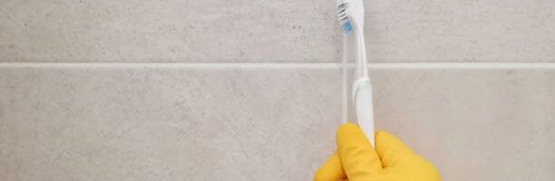 Cleaning bathroom titles and grout.